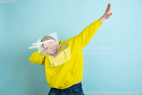 Image of Easter bunny man with bright emotions on blue studio background