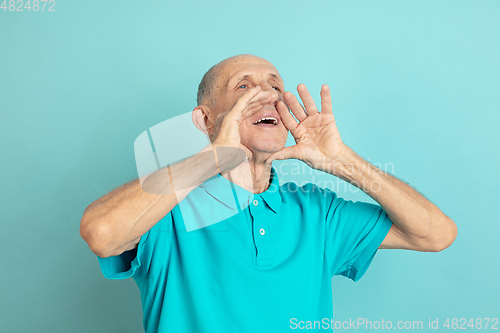 Image of Caucasian senior man\'s portrait isolated on blue studio background