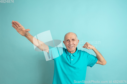 Image of Caucasian senior man\'s portrait isolated on blue studio background