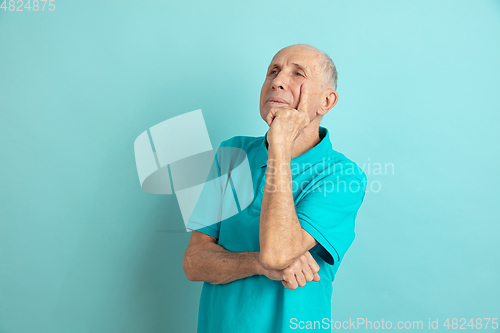 Image of Caucasian senior man\'s portrait isolated on blue studio background