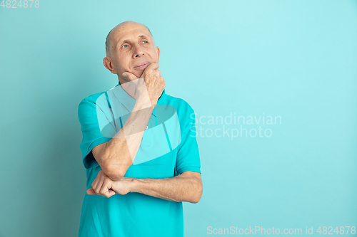 Image of Caucasian senior man\'s portrait isolated on blue studio background