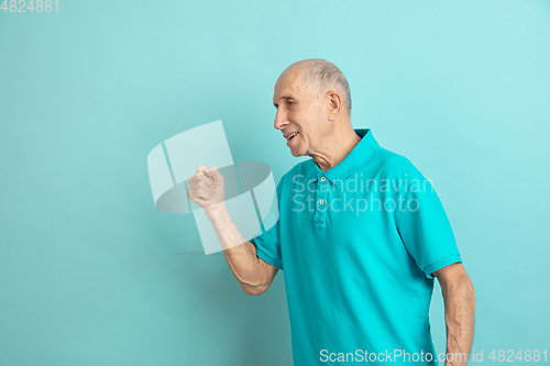 Image of Caucasian senior man\'s portrait isolated on blue studio background