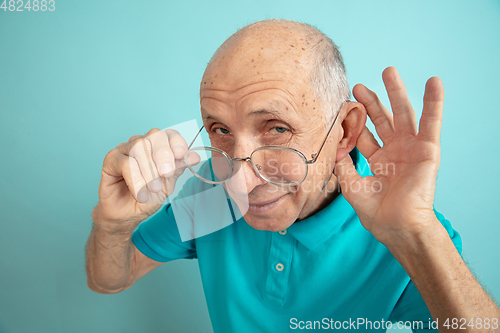 Image of Caucasian senior man\'s portrait isolated on blue studio background