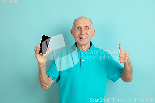 Image of Caucasian senior man\'s portrait isolated on blue studio background