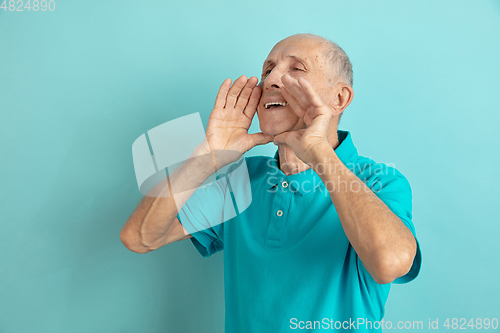 Image of Caucasian senior man\'s portrait isolated on blue studio background