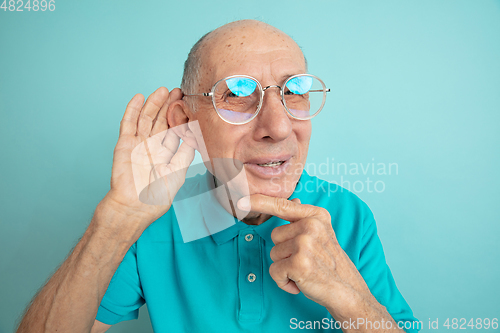 Image of Caucasian senior man\'s portrait isolated on blue studio background