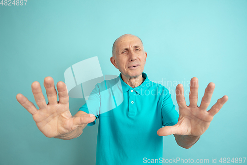 Image of Caucasian senior man\'s portrait isolated on blue studio background