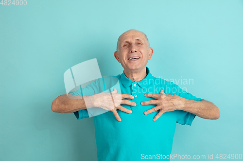 Image of Caucasian senior man\'s portrait isolated on blue studio background