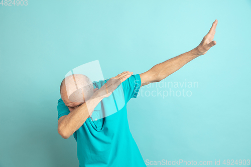 Image of Caucasian senior man\'s portrait isolated on blue studio background