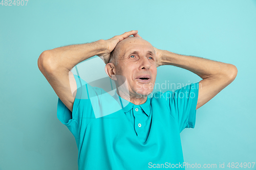 Image of Caucasian senior man\'s portrait isolated on blue studio background