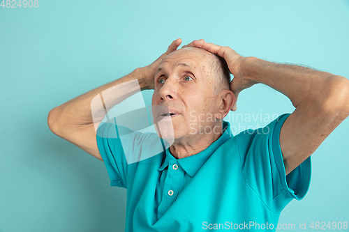 Image of Caucasian senior man\'s portrait isolated on blue studio background