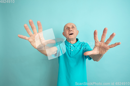 Image of Caucasian senior man\'s portrait isolated on blue studio background