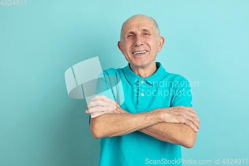 Image of Caucasian senior man\'s portrait isolated on blue studio background