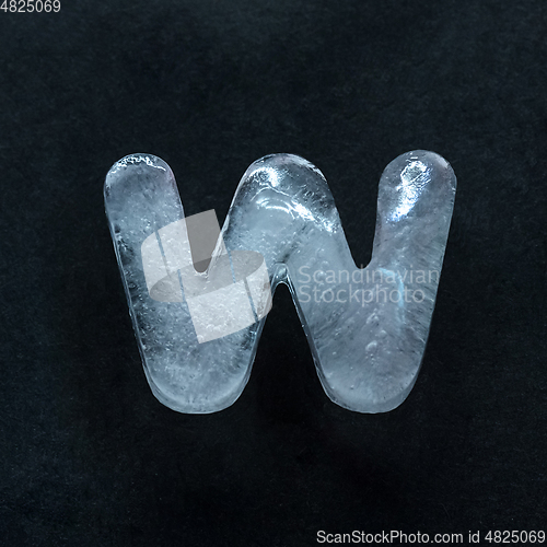 Image of Alphabet\'s letters made out of ice isolated on dark studio background