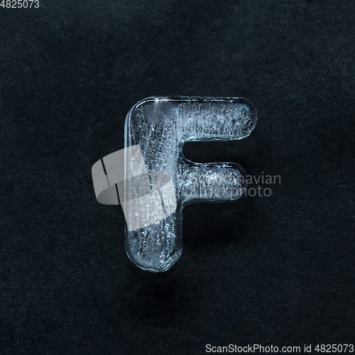 Image of Alphabet\'s letters made out of ice isolated on dark studio background