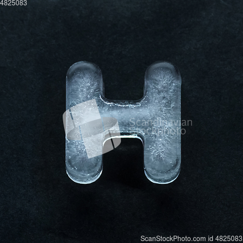 Image of Alphabet\'s letters made out of ice isolated on dark studio background