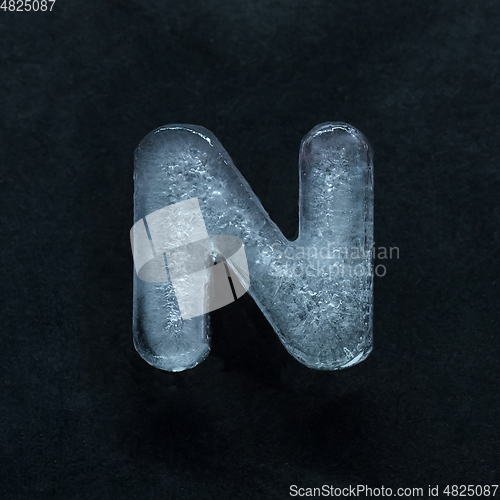 Image of Alphabet\'s letters made out of ice isolated on dark studio background