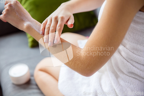 Image of Beauty Day. Woman doing her daily skincare routine at home