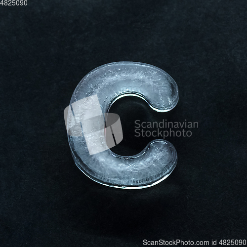 Image of Alphabet\'s letters made out of ice isolated on dark studio background