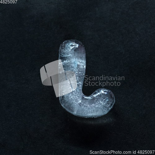 Image of Alphabet\'s letters made out of ice isolated on dark studio background