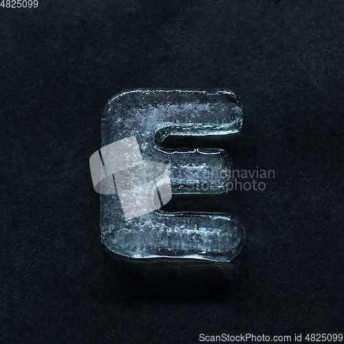 Image of Alphabet\'s letters made out of ice isolated on dark studio background