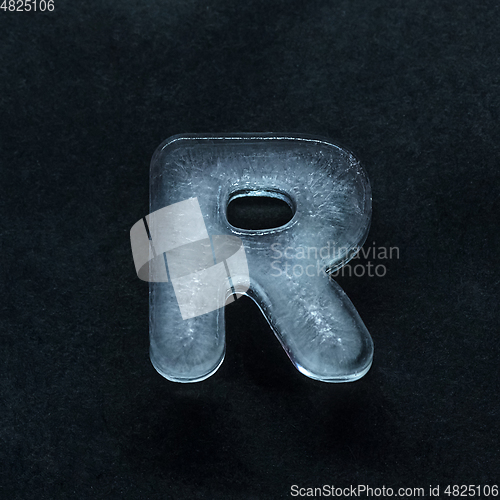 Image of Alphabet\'s letters made out of ice isolated on dark studio background