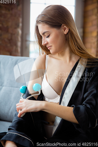 Image of Beauty Day. Woman doing her daily skincare routine at home