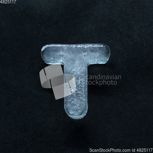 Image of Alphabet\'s letters made out of ice isolated on dark studio background