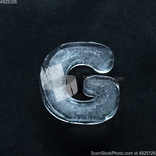 Image of Alphabet\'s letters made out of ice isolated on dark studio background