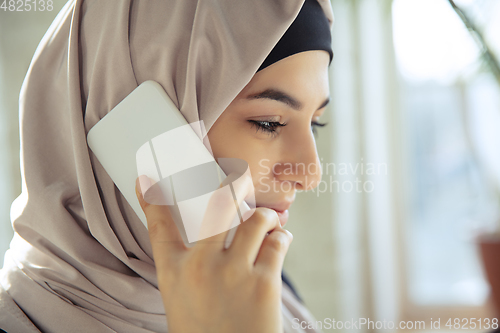 Image of Portrait of a beautiful arabian businesswoman wearing hijab while working