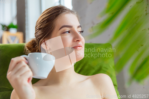 Image of Beauty Day. Woman doing her daily skincare routine at home