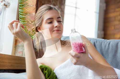 Image of Beauty Day. Woman doing her daily skincare routine at home