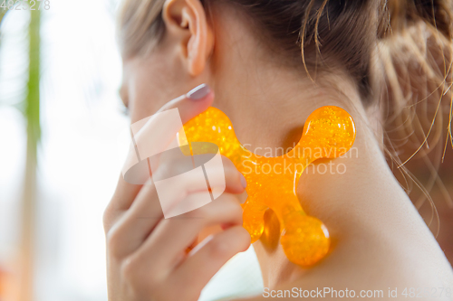 Image of Beauty Day. Woman doing her daily skincare routine at home