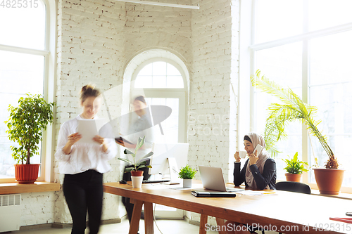 Image of Portrait of a beautiful arabian businesswoman wearing hijab while working