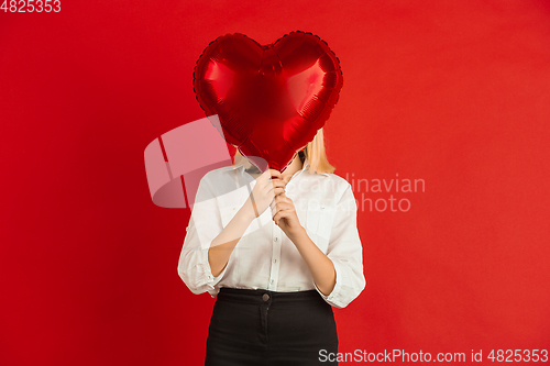 Image of Valentine\'s day celebration, happy caucasian kids isolated on red background