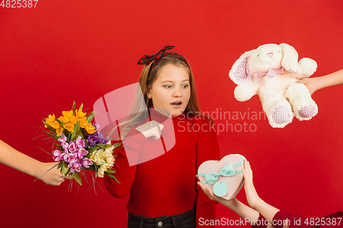 Image of Valentine\'s day celebration, happy caucasian girl isolated on red background