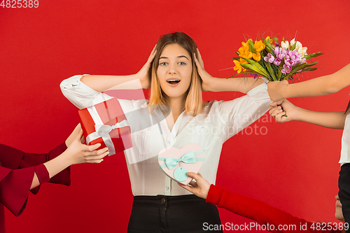 Image of Valentine\'s day celebration, happy caucasian girl isolated on red background