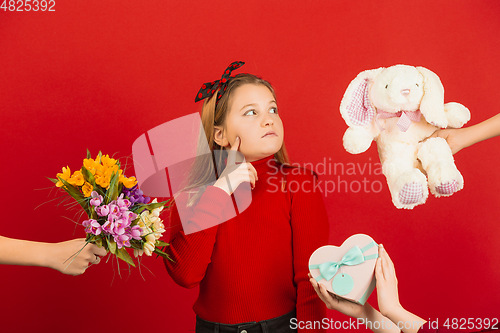 Image of Valentine\'s day celebration, happy caucasian girl isolated on red background