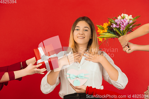 Image of Valentine\'s day celebration, happy caucasian girl isolated on red background