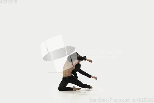 Image of Man in casual style clothes jumping and dancing isolated on white background. Art, motion, action, flexibility, inspiration concept. Flexible caucasian ballet dancer.