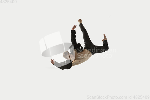 Image of Man in casual style clothes jumping and dancing isolated on white background. Art, motion, action, flexibility, inspiration concept. Flexible caucasian ballet dancer.