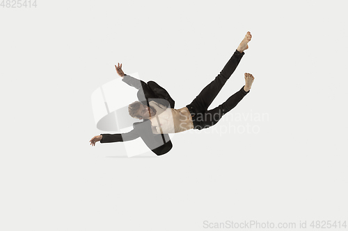 Image of Man in casual style clothes jumping and dancing isolated on white background. Art, motion, action, flexibility, inspiration concept. Flexible caucasian ballet dancer.