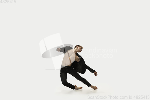 Image of Man in casual style clothes jumping and dancing isolated on white background. Art, motion, action, flexibility, inspiration concept. Flexible caucasian ballet dancer.
