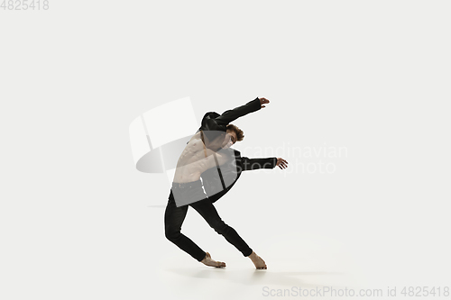 Image of Man in casual style clothes jumping and dancing isolated on white background. Art, motion, action, flexibility, inspiration concept. Flexible caucasian ballet dancer.