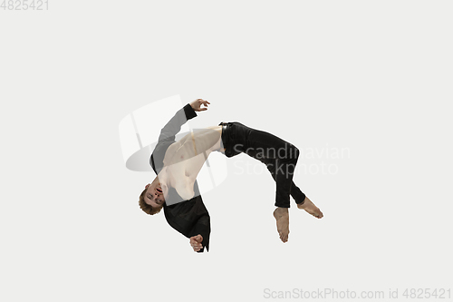 Image of Man in casual style clothes jumping and dancing isolated on white background. Art, motion, action, flexibility, inspiration concept. Flexible caucasian ballet dancer.