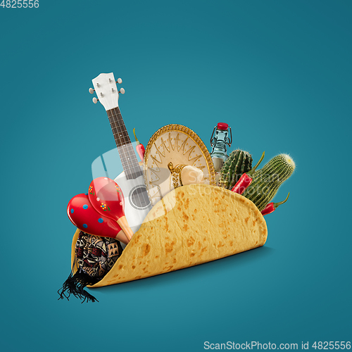 Image of Fresh and tasty taco filled with Sombrero, Ukulele, Maracas, cactus, drink on blue background.