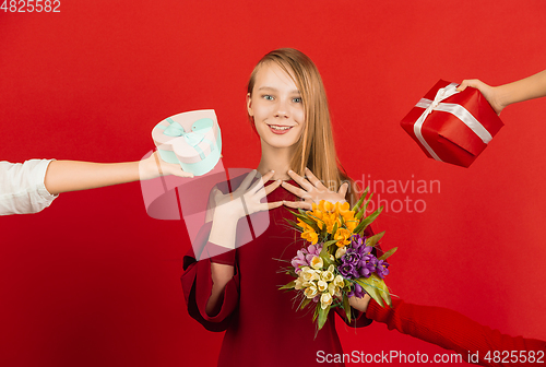 Image of Valentine\'s day celebration, happy caucasian girl isolated on red background