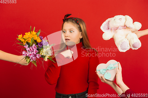 Image of Valentine\'s day celebration, happy caucasian girl isolated on red background