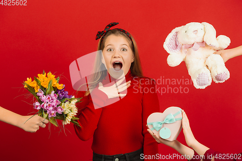 Image of Valentine\'s day celebration, happy caucasian girl isolated on red background