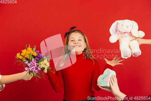 Image of Valentine\'s day celebration, happy caucasian girl isolated on red background